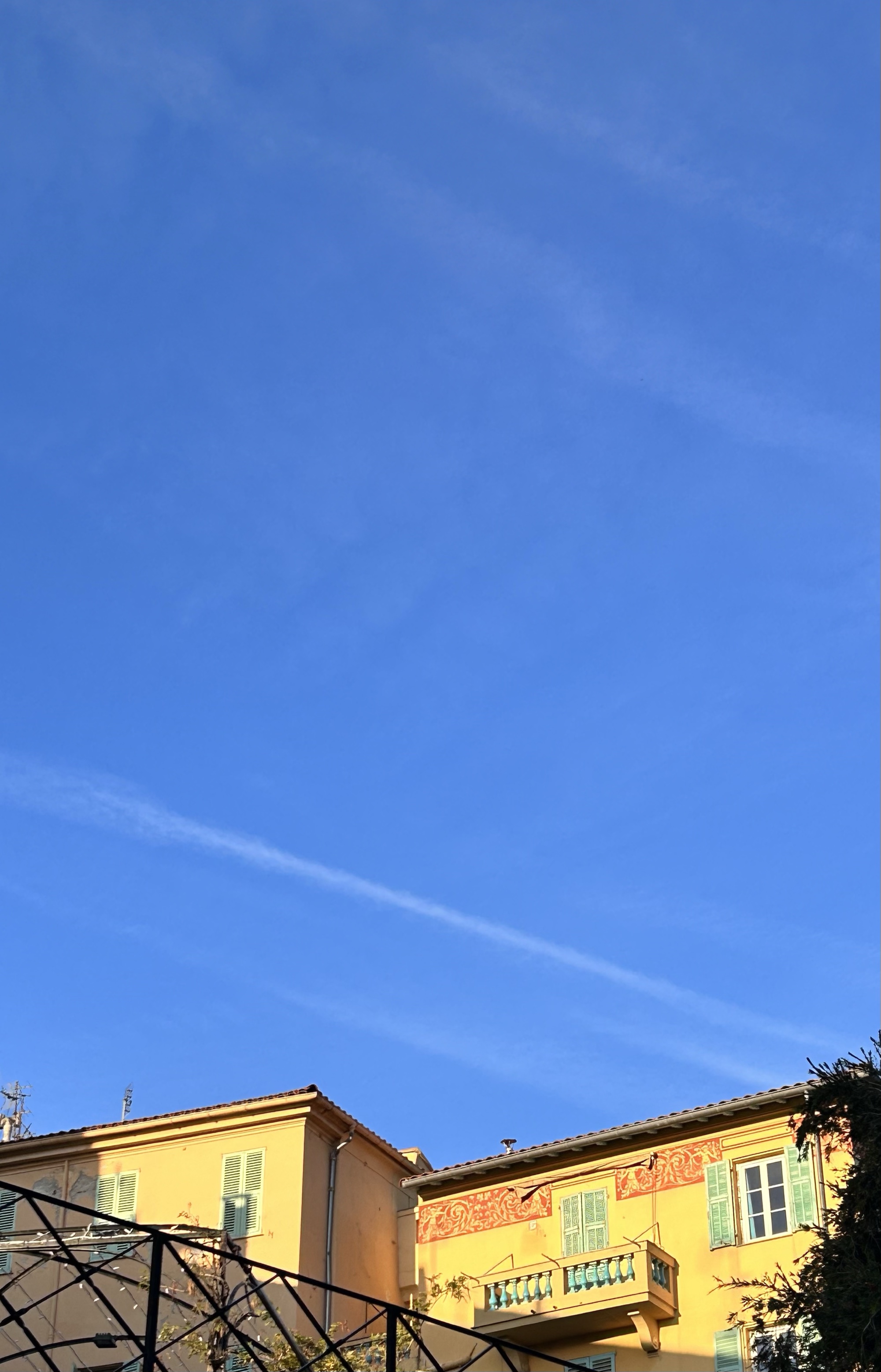 Sunlit Mediterranean buildings beneath a deep blue sky